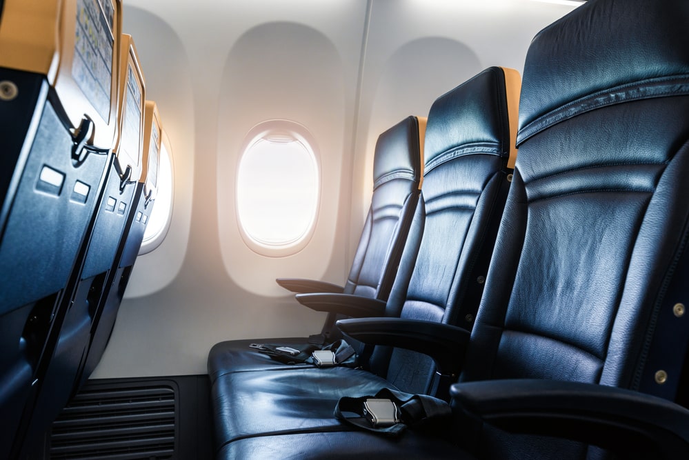  row of leather seats on a jet airplane